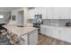 Well-equipped kitchen with stainless steel appliances, a breakfast bar, and stylish countertops at 168 Warbler Way, Mcdonough, GA 30253
