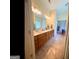 Large bathroom with double vanity, wood cabinets, and updated lighting fixtures with tile flooring at 180 Tabor Forest Dr, Oxford, GA 30054