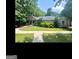 Charming single-story home with a covered front porch and lush landscaping surrounding the property at 180 Tabor Forest Dr, Oxford, GA 30054