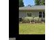 Backyard garden area with raised garden beds, black metal fencing, and lush green lawn at 180 Tabor Forest Dr, Oxford, GA 30054