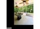 Covered outdoor living space with ceiling fans, room for seating and a view of the wooded backyard at 180 Tabor Forest Dr, Oxford, GA 30054