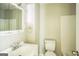 Bright bathroom featuring white fixtures and a large mirror above the vanity sink at 6770 Burkhead Dr, Union City, GA 30291