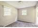 Sunlit bedroom with neutral walls, plush gray carpet, and windows offering a pleasant view of the surrounding greenery at 6770 Burkhead Dr, Union City, GA 30291