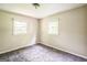 Bedroom with two windows providing natural light and neutral walls and carpeted floor at 6770 Burkhead Dr, Union City, GA 30291