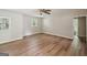 Bright bedroom featuring modern flooring, a ceiling fan, and natural light from two windows at 6770 Burkhead Dr, Union City, GA 30291