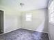 Well-lit bedroom with neutral walls, gray carpet, and two windows allowing ample natural light to fill the space at 6770 Burkhead Dr, Union City, GA 30291