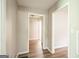 Inviting hallway featuring wood-look flooring and neutral wall color, creating a seamless transition between rooms at 6770 Burkhead Dr, Union City, GA 30291