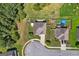 Aerial view of property shows mature trees, well-maintained landscaping, spacious backyard, and neighborhood water feature at 4770 Macy Way, Ellenwood, GA 30294