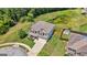 Aerial view of a brick two-story home with a fenced backyard, mature trees, and a nearby pond at 4770 Macy Way, Ellenwood, GA 30294