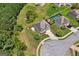 Aerial view captures lush trees, well-maintained landscaping, spacious backyard, and community water feature at 4770 Macy Way, Ellenwood, GA 30294