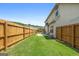 Private backyard featuring a patio, grassy area and a wood fence at 4770 Macy Way, Ellenwood, GA 30294