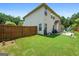 Spacious backyard featuring a well-maintained lawn, privacy fence, and outdoor patio perfect for entertaining guests at 4770 Macy Way, Ellenwood, GA 30294
