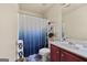 Cozy bathroom with shower curtain, cherry vanity and standard toilet at 4770 Macy Way, Ellenwood, GA 30294