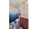 Cozy bathroom with shower curtain, cherry vanity and standard toilet at 4770 Macy Way, Ellenwood, GA 30294
