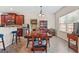 Cozy dining room with wooden table set, china cabinets, and a bright window, adjacent to the kitchen at 4770 Macy Way, Ellenwood, GA 30294