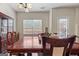 Inviting dining room area featuring a wooden table and chairs set with window view and door to the backyard at 4770 Macy Way, Ellenwood, GA 30294