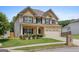 Charming two-story brick home featuring a covered front porch, attached two car garage and landscaped front yard at 4770 Macy Way, Ellenwood, GA 30294