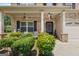Inviting front porch featuring classic columns, lush landscaping, and a charming seating area for relaxing at 4770 Macy Way, Ellenwood, GA 30294