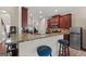 Well-lit kitchen featuring granite countertops, stainless steel appliances, and a breakfast bar with stylish blue stools at 4770 Macy Way, Ellenwood, GA 30294