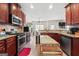 Open-concept kitchen featuring rich wood cabinets, stainless appliances, and a breakfast bar, perfect for entertaining at 4770 Macy Way, Ellenwood, GA 30294