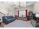 Cozy living room with gray sofa, large windows, and coffered ceiling offering an ideal space to unwind at 4770 Macy Way, Ellenwood, GA 30294