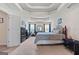 Spacious main bedroom features a tray ceiling, comfortable bed, ample closet space, and soft carpeting at 4770 Macy Way, Ellenwood, GA 30294