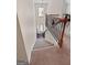 Carpeted staircase with wooden railings and a landing illuminated by a window, leading to the upper level at 4770 Macy Way, Ellenwood, GA 30294