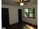 Bedroom featuring light walls, wood floor, two doors, and a window at 4350 Lincolndale Dr, Ellenwood, GA 30294
