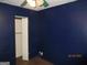 Bedroom featuring a closet, blue wall, wood floor, and a ceiling fan at 4350 Lincolndale Dr, Ellenwood, GA 30294