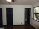 Bright bedroom with two doors, wood floor, and a window bringing in natural light at 4350 Lincolndale Dr, Ellenwood, GA 30294