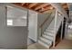 Basement leading to stairs, featuring white walls and concrete floors at 4852 Pine Shadows, Stone Mountain, GA 30088