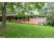 Charming brick home featuring a well-manicured lawn and a cozy front porch at 4852 Pine Shadows, Stone Mountain, GA 30088