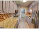 Galley kitchen features granite countertops, stainless steel appliances, and stylish backsplash at 4852 Pine Shadows, Stone Mountain, GA 30088