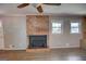 Cozy living room featuring a brick fireplace and wood-look flooring at 4852 Pine Shadows, Stone Mountain, GA 30088