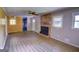 Open living area with a fireplace, wood floors, and large windows at 4852 Pine Shadows, Stone Mountain, GA 30088