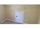 Attic access featuring a small white door, closet rod, and neutral carpeting at 4199 Elderberry Nw Dr, Acworth, GA 30101