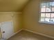 Attic access features a small door, closet rod, and window letting in natural light at 4199 Elderberry Nw Dr, Acworth, GA 30101