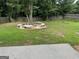 Backyard with a tree, surrounded by a picnic table with benches, and privacy fence at 4199 Elderberry Nw Dr, Acworth, GA 30101