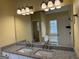 Bathroom with double sinks, granite countertops, and a large mirror at 4199 Elderberry Nw Dr, Acworth, GA 30101