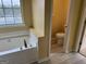 A relaxing bathroom with a large bathtub, and a toilet in the side room at 4199 Elderberry Nw Dr, Acworth, GA 30101