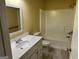 Bathroom with toilet, sink, vanity, and tub-shower combo with white tiles at 4199 Elderberry Nw Dr, Acworth, GA 30101