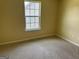 Cozy bedroom with a double-paned window offering abundant natural light, and carpeted floors at 4199 Elderberry Nw Dr, Acworth, GA 30101