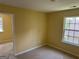This is a bedroom with carpeted floors, natural light from the windows, and bright painted walls at 4199 Elderberry Nw Dr, Acworth, GA 30101