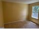 Comfortable bedroom with neutral carpet, walls painted in a soft tan, and a double-paned window at 4199 Elderberry Nw Dr, Acworth, GA 30101