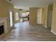Open concept living area with a fireplace, vinyl floors, and access to the kitchen at 4199 Elderberry Nw Dr, Acworth, GA 30101