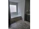 Bright bathroom with a soaking tub, gray vanity, tiled floors, and ample counter space at 1945 Labonte Pkwy # 42, Mcdonough, GA 30253