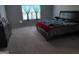 Carpeted bedroom with a queen-sized bed, a dresser, and a large window with natural light at 1945 Labonte Pkwy # 42, Mcdonough, GA 30253