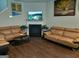 Cozy living room with a fireplace, hardwood floors, comfortable sofas, and a mounted flatscreen TV at 1945 Labonte Pkwy # 42, Mcdonough, GA 30253
