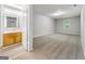 Spacious bedroom with neutral carpet, paint, and a wood vanity with sink and window at 2039 Faith Cv, Atlanta, GA 30349