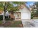 Inviting single-story home featuring a garage, landscaped front yard, and a charming entrance at 167 London Dr, Mcdonough, GA 30253